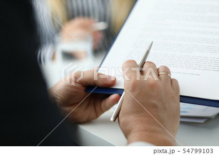 Businessman reading text of agreement 54799103