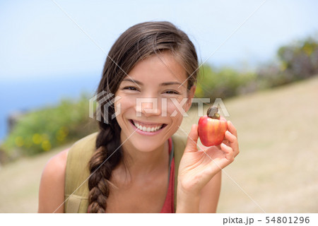 Girl showing natural fresh cashew nut apple fruit 54801296