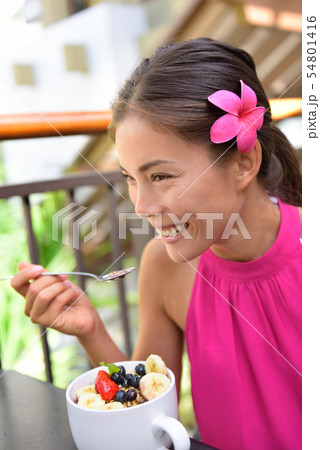 Acai bowl - girl eating healthy food outside 54801416