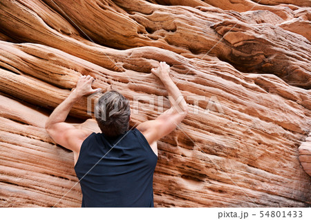 Climber man free climbing on rock Climber man free climbing on rock 54801433
