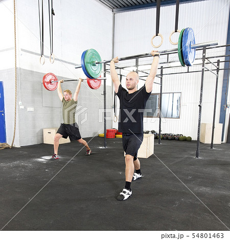 Clean and jerk workout at fitness gym center 54801463