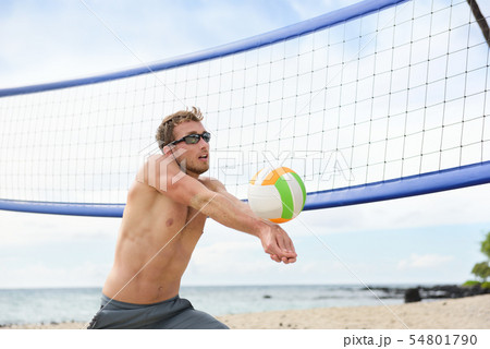 Beach volleyball man playing game hitting ball 54801790