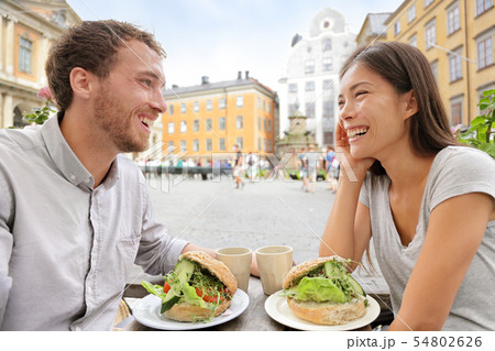 Cafe couple eating food sandwiches in Stockholm 54802626