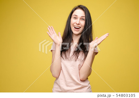 Surprised young girl on yellow isolated background Surprised young girl on yellow isolated background 54803105