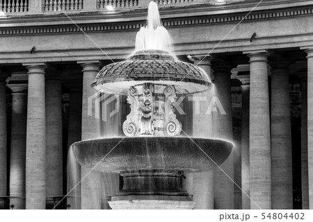 Illuminated Bernini Fountain at St Peters Basilica in the evening dusk. St Peters Square, Vatican 54804402