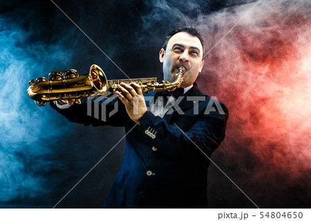 Handsome adult man playing saxophone Handsome adult man playing saxophone 54804650