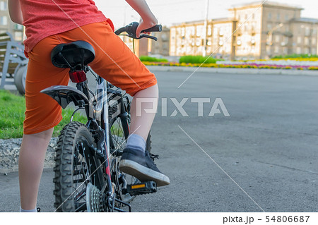 view of a teenager who sits on a bike 54806687