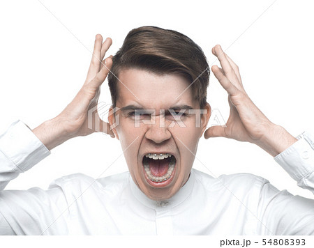 portrait of a creaming young man on white background 54808393