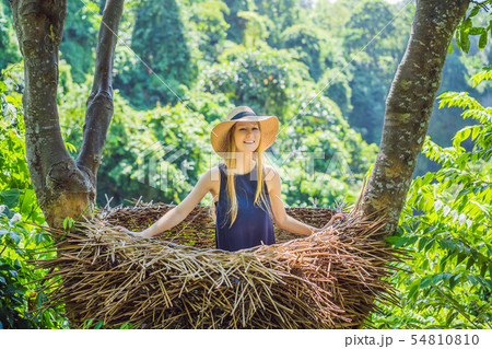 Bali trend, straw nests everywhere. Young tourist enjoying her travel around Bali island, Indonesia Bali trend, straw nests everywhere. Young tourist enjoying her travel around Bali island, Indonesia 54810810
