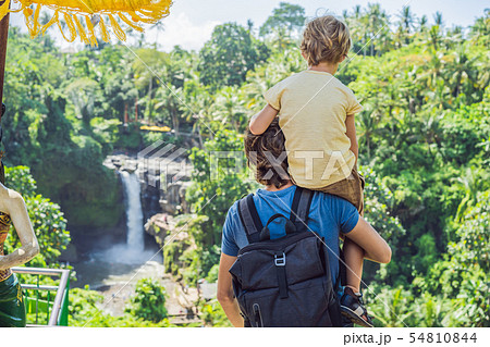 Dad and son tourists on the background of a waterfall. Traveling with kids concept. What to do with Dad and son tourists on the background of a waterfall. Traveling with kids concept. What to do with 54810844