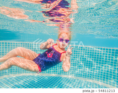 The little girl in the water park swimming underwater and smiling 54811213