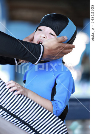 asian boy wearing a blue rubber swimming cap in 54813908