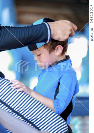 asian boy wearing a blue rubber swimming cap in 54813917