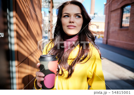 The girl in the yellow coat on the street, stylish The girl in the yellow coat on the street, stylish 54815001