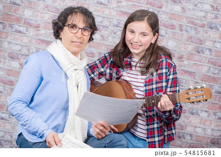 young teenager learning to play the guitar with young teenager learning to play the guitar with 54815681