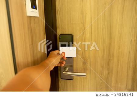 Man used key card for access digital door systems at the hotel room. 54816241