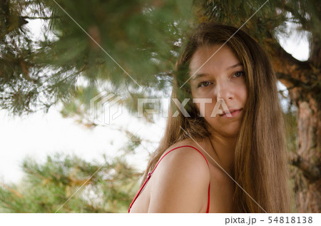 young woman in red dress nature fresh air 54818138