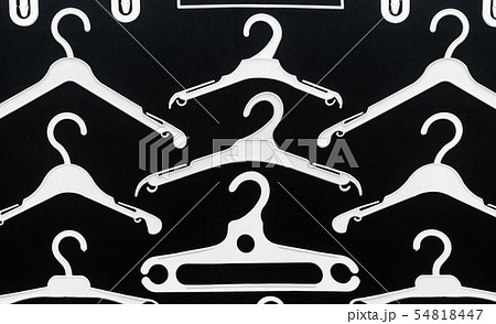 white plastic hanger on a black background 54818447