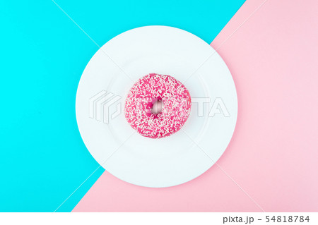 Donut covered with icing in plate, top view 54818784