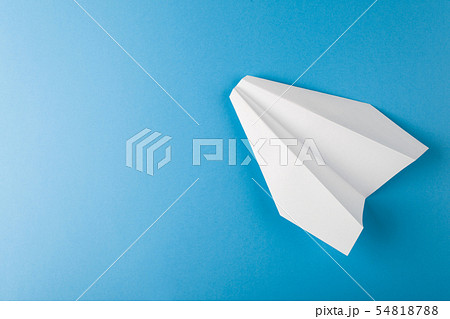 Flat lay of white paper plane and blank paper on pastel blue color background Flat lay of white paper plane and blank paper on pastel blue color background 54818788