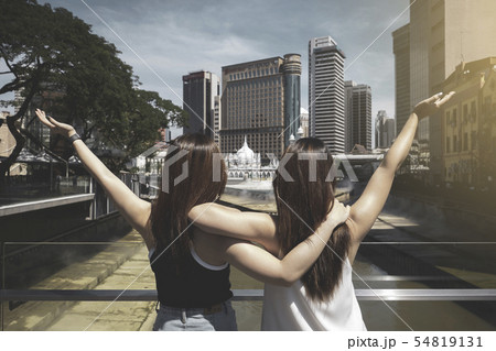 Rear of two young women enjoy theirs holiday  54819131