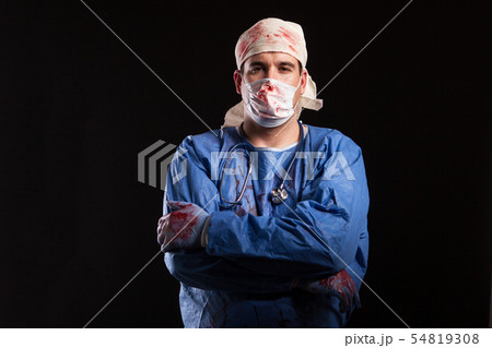 Man in doctor costume for halloween looking with a bizzare face at the camera Man in doctor costume for halloween looking with a bizzare face at the camera 54819308