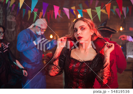 Portrait of sexy woman dressed up in a witch costume at halloween event Portrait of sexy woman dressed up in a witch costume at halloween event 54819536