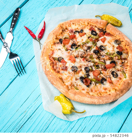 Vegetarian pizza with vegetables on blue table. 54822346