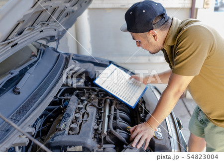 Mechanic technician man repair fixing car at home. Mechanic technician man repair fixing car at home. 54823004