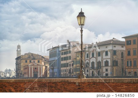 street with old houses along the banks of the Arno River in Pisa, Italy 54826850