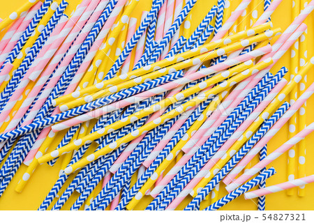 Striped, dotted paper straws scattered Flat lay 54827321