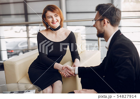 Stylish and elegant couple in a car salon 54827914