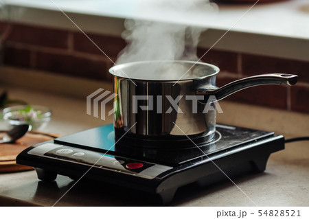 Saucepan with boiling water on the electric kitchen stove Saucepan with boiling water on the electric kitchen stove 54828521