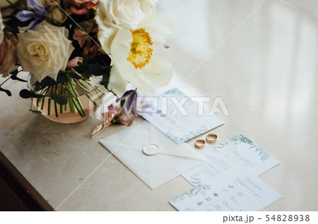 Wedding invitation card with the envelope, a ring in the jewel-box, satin ribbons on wedding table Wedding invitation card with the envelope, a ring in the jewel-box, satin ribbons on wedding table 54828938