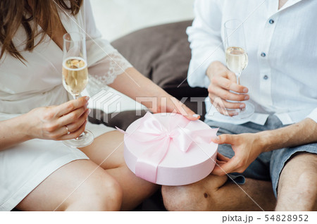 Portrait of beautiful happy couple man and woman are eating macaron biscuits Portrait of beautiful happy couple man and woman are eating macaron biscuits 54828952