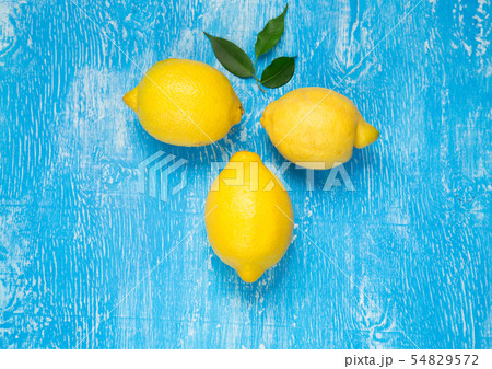 Yellow lemons on blue background. 54829572