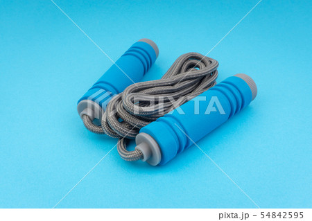 Skipping rope or jumping rope isolated on blue Skipping rope or jumping rope isolated on blue 54842595