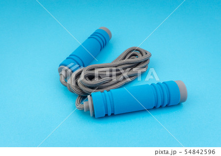 Skipping rope or jumping rope isolated on blue Skipping rope or jumping rope isolated on blue 54842596