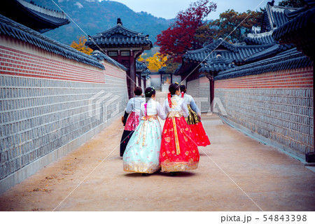 Lady in hanbok dress walk in seoul palace in 54843398