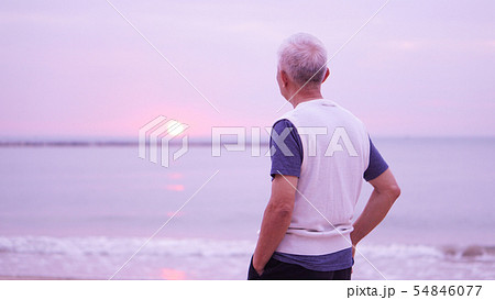 Asian senior man standing alone at sunrise morning 54846077