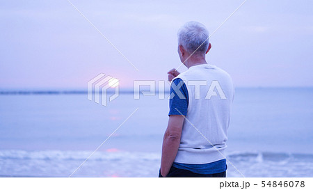 Asian senior man standing alone at sunrise morning 54846078