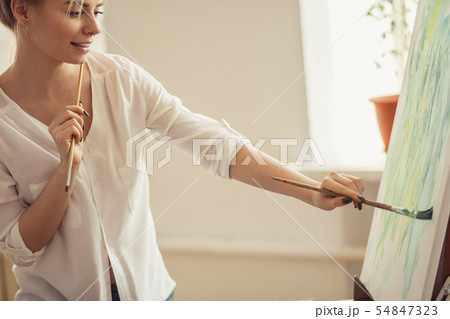 young cheerful nice girl making up a paint 54847323