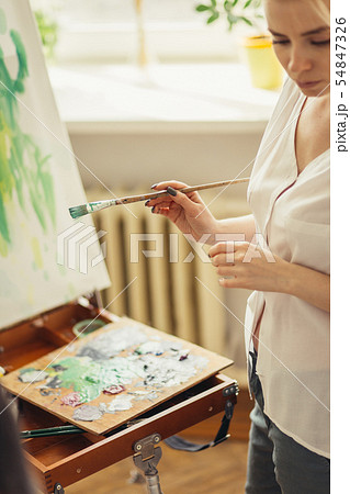 young talented artist taking part in a workshop young talented artist taking part in a workshop 54847326
