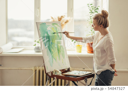 awesome woman applying paint on the paper awesome woman applying paint on the paper 54847327