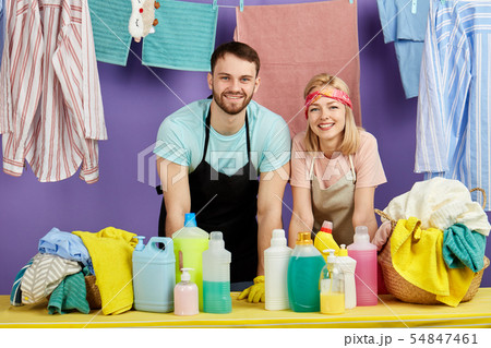 positive awesome man and woman in aprions leaning on the table and looking at the camera positive awesome man and woman in aprions leaning on the table and looking at the camera 54847461