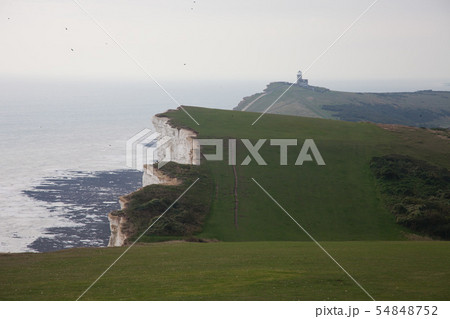 White chalk cliffs and Beachy Head Lighthouse. Eastbourne, East Sussex, England. Highest chalk sea White chalk cliffs and Beachy Head Lighthouse. Eastbourne, East Sussex, England. Highest chalk sea 54848752