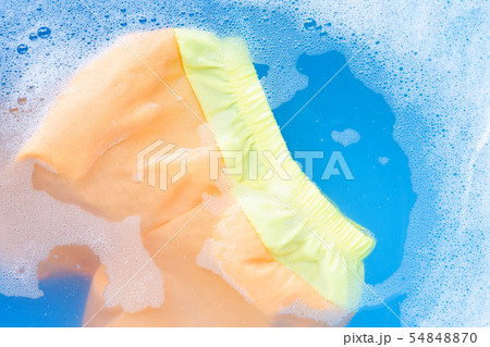 Yellow and orange baby shorts soak in water 54848870