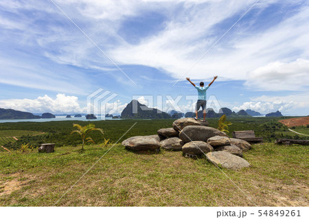 Young traveler man standing relax and hands raised Young traveler man standing relax and hands raised 54849261