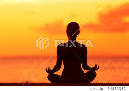 Wellness woman doing zen yoga meditation on beach Wellness woman doing zen yoga meditation on beach 54851382