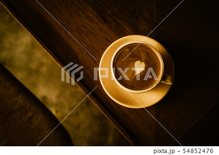 Cappuccino coffee with heart in yellow cup 54852476